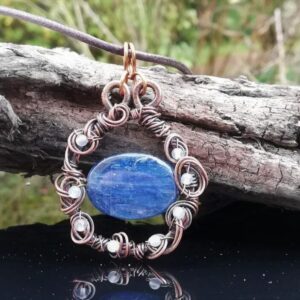 pendant of blue kyanite stone wrapped in copper wire