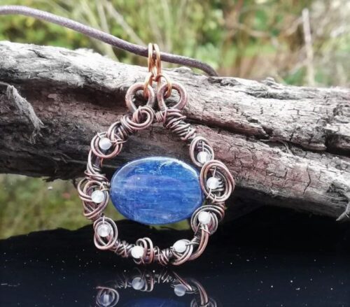 pendant of blue kyanite stone wrapped in copper wire