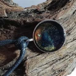 Galaxy pendant with blue centre silver tone bezel black cord necklace