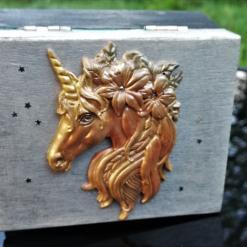 black and silver trinket box with golden unicorn head