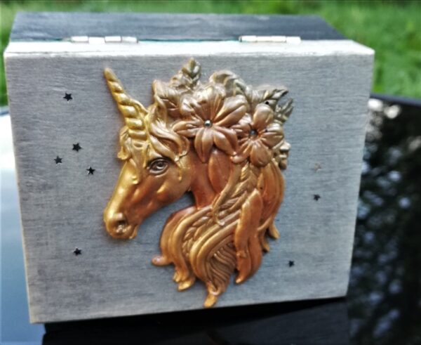 black and silver trinket box with golden unicorn head