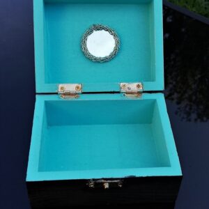 turquoise blue with round mirror. Inside of black silver trinket box
