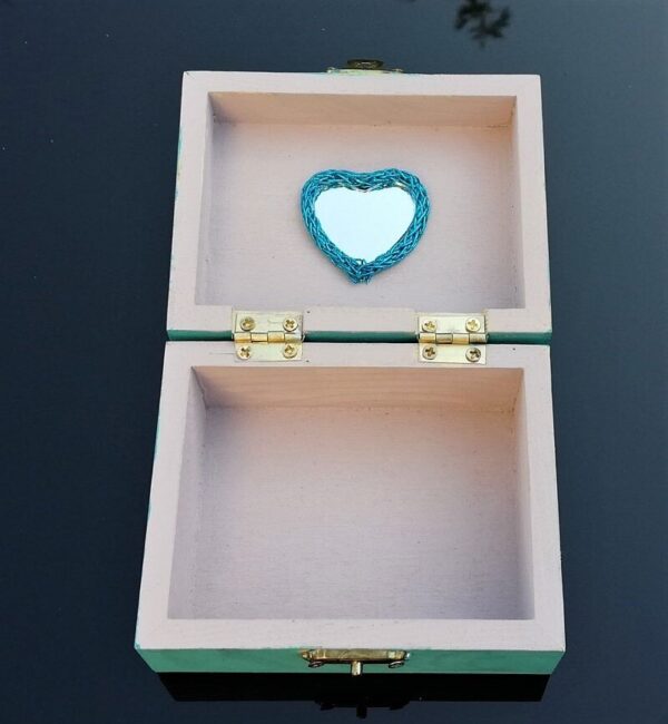 inside of blue dancing girl trinket box, dusty pink with heart shaped mirror
