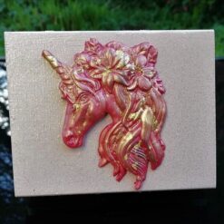 dusty pink trinket box with red gold unicorn head on the lid
