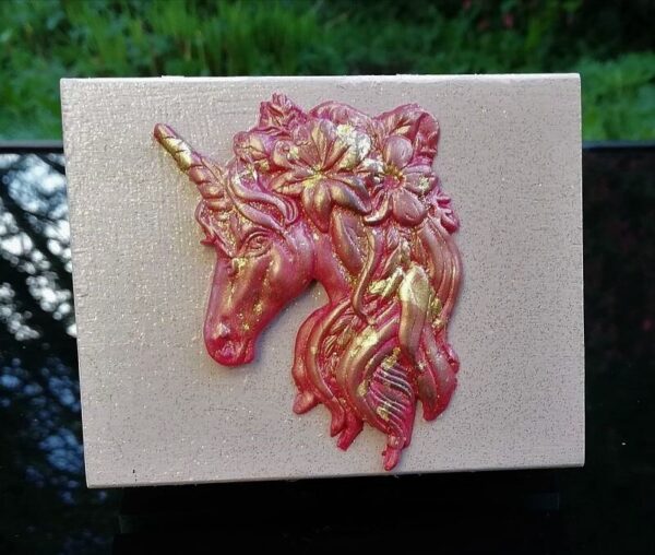 dusty pink trinket box with red gold unicorn head on the lid