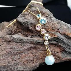 swarovski crystals set in gold over sterling silver with Aquamarine drop