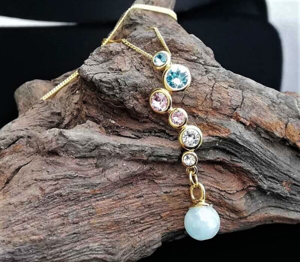 swarovski crystals set in gold over sterling silver with Aquamarine drop