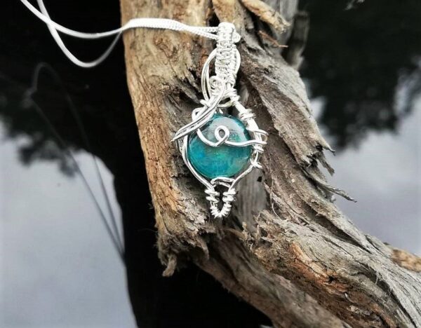 blue green Chrysocolla stone wrapped in Sterling Silver wire. Pendant necklace