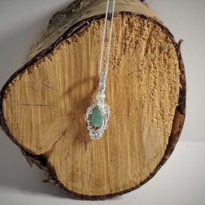 Pendant necklace of pale blue green Grandiderite with clear zircon. Wire wrapped with Sterling Silver on sterling silver chain.