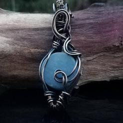 blue Angelite gemstone wrapped in copper wire.
