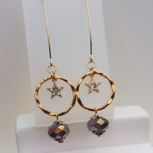 long gold tone drop earrings, star in a circle with a purple bead on the bottom of the circle