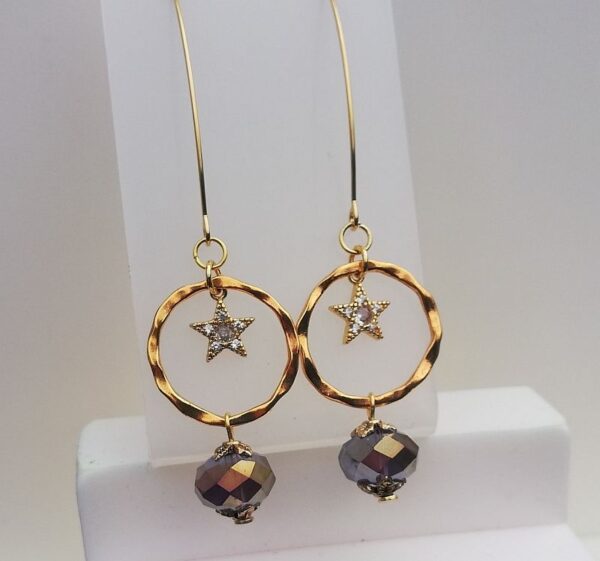 long gold tone drop earrings, star in a circle with a purple bead on the bottom of the circle