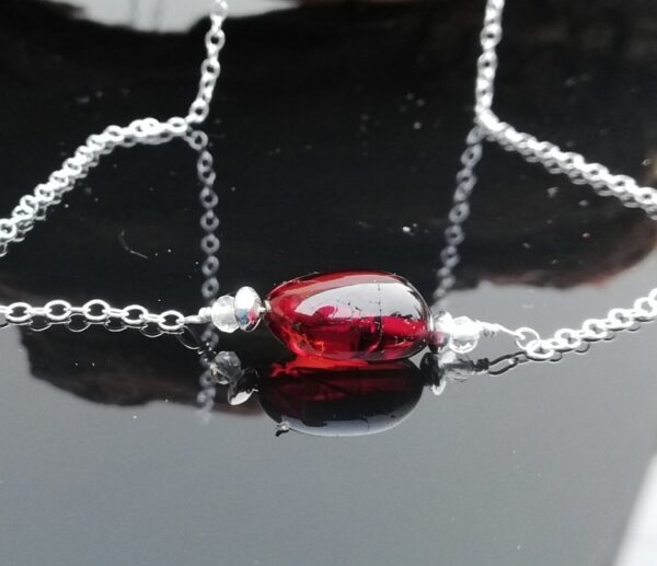 cherry amber stone with clear quartz and silver bead either side on silver chain