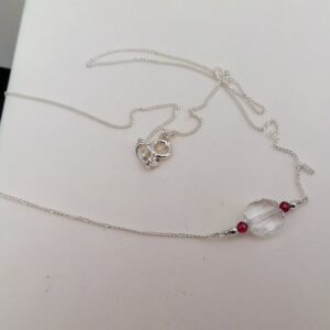 clear quartz round disc with red garnet stones. sterling silver necklace.