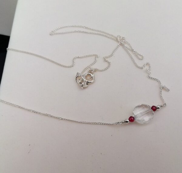 clear quartz round disc with red garnet stones. sterling silver necklace.