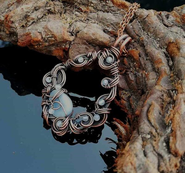 blue angelite and white agate stones in a frame of curled copper wire
