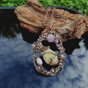 big pendant in copper with yellow stone, purple amethyst and white, brown and tiny stones.