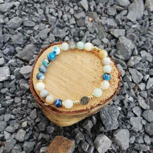shades of blue beads in a bracelet with a tree of life bead