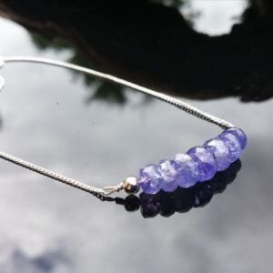 A necklace of 7 faceted rondelles of violet blue Tanzanite stones on Sterling silver.